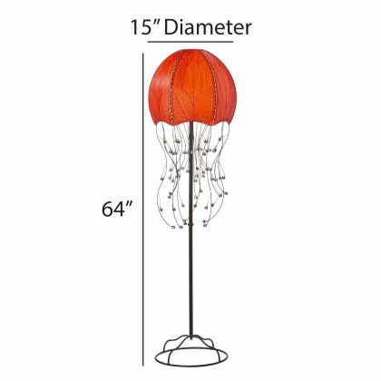 In a entryway beside a console table, the Jellyfish Large Floor crafted by the artisans of Eangee Home Design Lamp in red finish by Eangee Home Design stands beside a neutral sofa, its fossilized cocoa leaf panels, powder coated wrought iron frame, wrought iron frame, and hand placed natural leaves casting a warm glow that there's something hypnotic about it this lamp moves you before it ever moves.