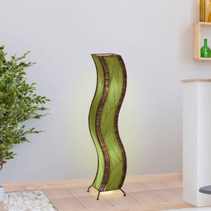 In a quiet bedside corner, crafted by the artisans of Eangee Home Design, the Wave Large Floor Lamp in green stands gracefully, featuring fossilized cocoa leaf shade, abaca rope accents, handcrafted, adding warmth and character to the space.