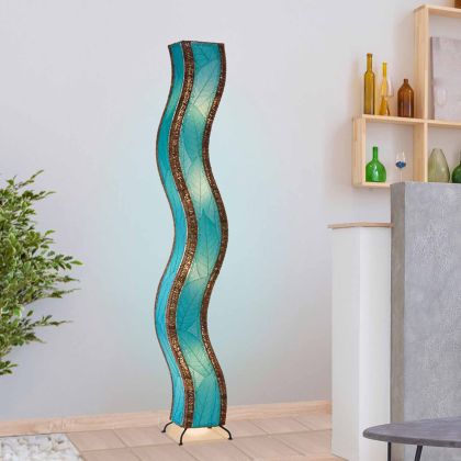 Crafted by the artisans of Eangee Home Design, the Wave Giant Floor Lamp in sea blue against a clean backdrop, featuring fossilized cocoa leaf shade, abaca rope accents, eco friendly, handcrafted.