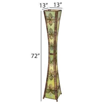 In a minimalist den with wooden accents, the Hourglass Giant Floor crafted by the artisans of Eangee Home Design Lamp in green finish by Eangee Home Design stands tall, its jackfruit leaf panels, abaca twine accents, wrought iron frame, hand placed natural leaves, and hand placed leaf panels casting a warm glow that this lamp doesn't just light a room it transforms it.