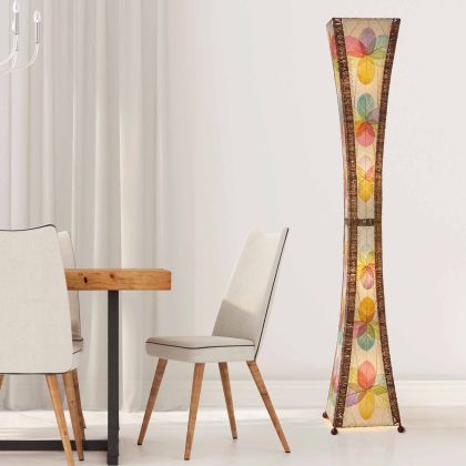 In a softly lit reading nook, crafted by the artisans of Eangee Home Design, the Hourglass Giant Floor Lamp in multi color stands gracefully, featuring jackfruit leaf panels, abaca rope accents, wrought iron frame, eco friendly, handcrafted, adding warmth and character to the space.
