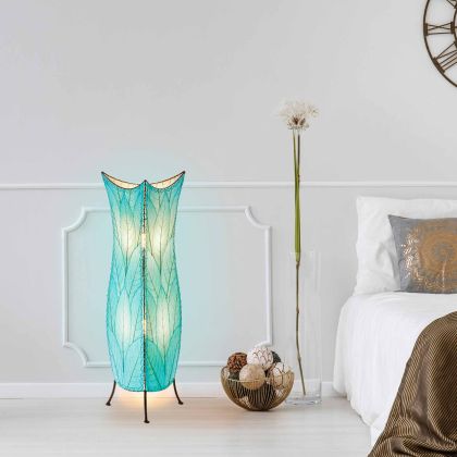 In a modern interior with earth tones, crafted by the artisans of Eangee Home Design, the Flowerbud Large Floor Lamp in sea blue stands gracefully, featuring fossilized cocoa leaf shade, adding warmth and character to the space.