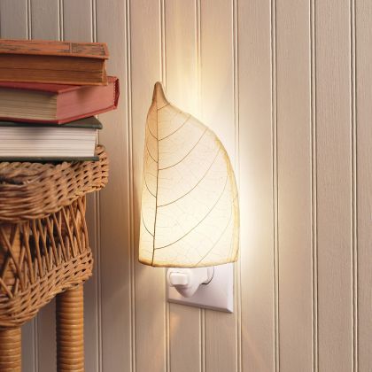 Crafted by the artisans of Eangee Home Design, the Leaf Nightlight in natural against a clean backdrop, featuring fossilized cocoa leaf shade, eco friendly, handcrafted.