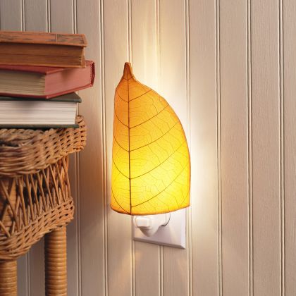 Crafted by the artisans of Eangee Home Design, the Leaf Nightlight in orange against a clean backdrop, featuring fossilized cocoa leaf shade, eco friendly, handcrafted.