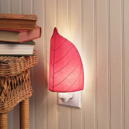 Crafted by the artisans of Eangee Home Design, the Leaf Nightlight in red against a clean backdrop, featuring fossilized cocoa leaf shade, eco friendly, handcrafted.