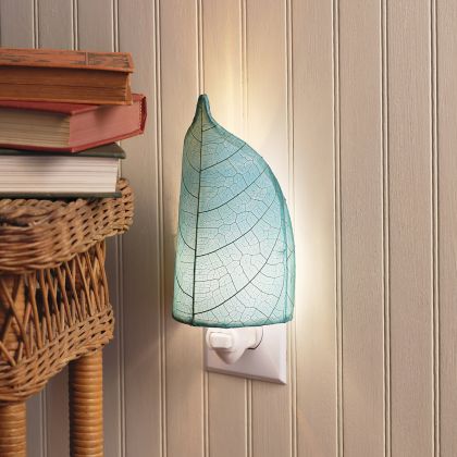 Crafted by the artisans of Eangee Home Design, the Leaf Nightlight in sea blue against a clean backdrop, featuring fossilized cocoa leaf shade, eco friendly, handcrafted.