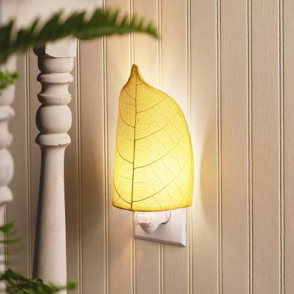 Crafted by the artisans of Eangee Home Design, the Leaf Nightlight in yellow against a clean backdrop, featuring fossilized cocoa leaf shade, eco friendly, handcrafted.