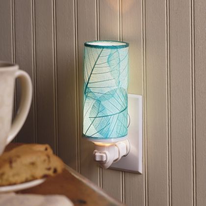 In a minimalist loft with natural textures, crafted by the artisans of Eangee Home Design, the Cylinder Nightlight in sea blue stands gracefully, featuring handcrafted detailing, fair trade, eco friendly, adding warmth and character to the space.