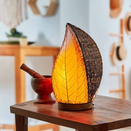 Crafted by the artisans of Eangee Home Design, the Leaflet Table Lamp in orange against a clean backdrop, featuring fossilized cocoa leaf shade, abaca rope accents, reclaimed mango wood base, wrought iron frame, sustainably sourced.