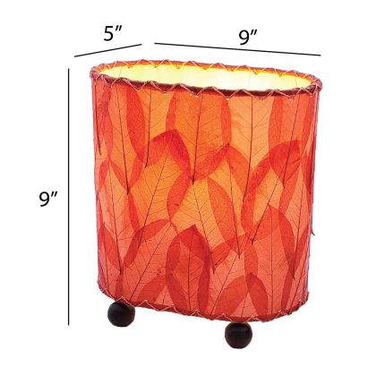 Crafted by the artisans of Eangee Home Design, the Mini Guyabano Table Lamp in red against a clean backdrop, featuring fossilized cocoa leaf shade, guyabano leaf shade, wrought iron frame.