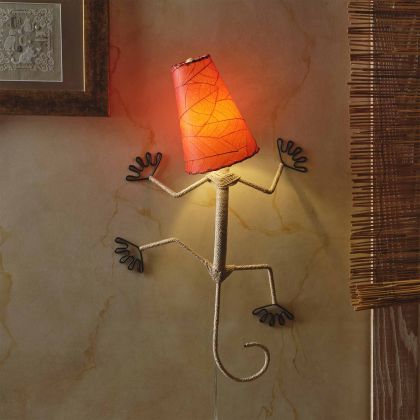 Crafted by the artisans of Eangee Home Design, the Gecko Wall Lamp Combo in red against a clean backdrop, featuring fossilized cocoa leaf shade, abaca rope accents, wrought iron frame, handcrafted.