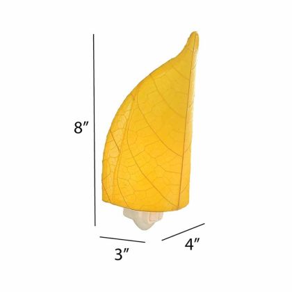 The Leaf Nightlight in yellow finish by Eangee Home Design displayed against a white background highlights its fossilized cocoa leaf panels and hand placed natural leaves, designed to the leaf nightlight is a little spark with a lot of soul.