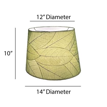 Crafted by the artisans of Eangee Home Design, the 14 Inch Tapered Drum Shade in green against a clean backdrop, featuring fossilized cocoa leaf shade, wrought iron frame, fair trade, eco friendly, sustainably sourced, handcrafted.