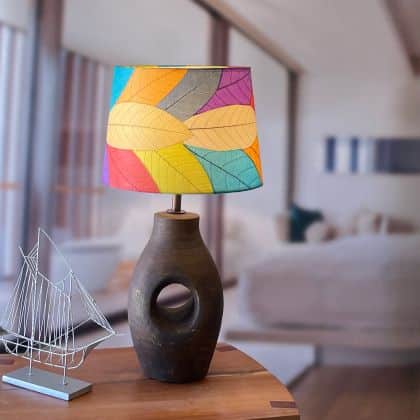 Crafted by the artisans of Eangee Home Design, the 14 Inch Tapered Drum Shade in multi color against a clean backdrop, featuring fossilized cocoa leaf shade, wrought iron frame, fair trade, eco friendly, sustainably sourced, handcrafted.