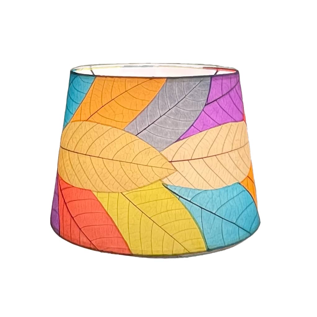 Crafted by the artisans of Eangee Home Design, the 14 Inch Tapered Drum Shade in multi color against a clean backdrop, featuring fossilized cocoa leaf shade, wrought iron frame, fair trade, eco friendly, sustainably sourced, handcrafted.
