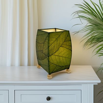 Crafted by the artisans of Eangee Home Design, the Mini Square Cocoa Leaf Table Lamp in green against a clean backdrop, featuring fossilized cocoa leaf shade, wrought iron frame, fair trade, eco friendly, sustainably sourced, handcrafted.