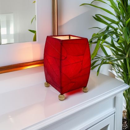 Crafted by the artisans of Eangee Home Design, the Mini Square Cocoa Leaf Table Lamp in red against a clean backdrop, featuring fossilized cocoa leaf shade, wrought iron frame, fair trade, eco friendly, sustainably sourced, handcrafted.