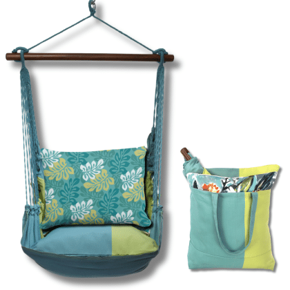 Multi colored outdoor swing crafted by the artisans of Magnolia Casual called the Swing Set 4 piece Meadow Mist Stripe w/ Tropical Flow featuring 100 percent weather resistant fabric, weather resistant polyester fabric, handcrafted, natural materials shown against a clean backdrop featuring with a stripe motif.