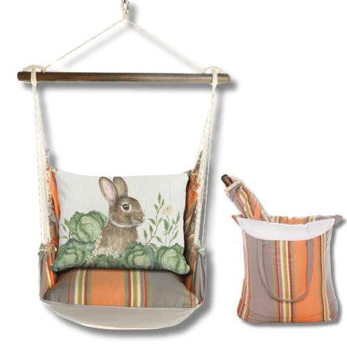 Multi colored outdoor swing crafted by the artisans of Magnolia Casual called the Swing Set 4 piece Serene Sunset w/ Rabbit and Cabbages featuring 100 percent weather resistant fabric, weather resistant polyester fabric, handcrafted shown against a clean backdrop featuring with a rabbit motif.