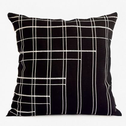Black pillow cover crafted by the artisans of Dos Tierras called the Broken Grid Pillow Cover Black featuring handwoven textile, handcrafted shown against a clean backdrop featuring with a grid motif and shades of black.