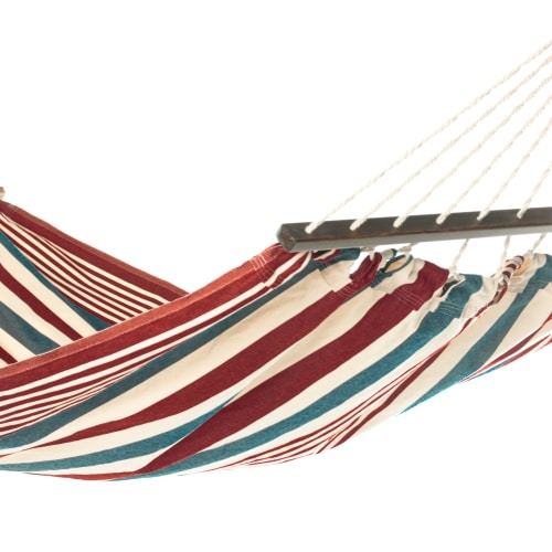 Multi colored outdoor textile crafted by the artisans of Magnolia Casual called the Hammock Stars & Stripes featuring 100 percent weather resistant fabric, weather resistant polyester fabric, sustainably sourced, artisan shown against a clean backdrop featuring with a stripes motif.