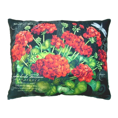 Red outdoor pillow crafted by the artisans of Magnolia Casual called the Outdoor Pillow Red Geranium featuring handwoven textile shown against a clean backdrop featuring shades of red.