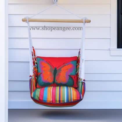 In a coastal inspired deck chair a red outdoor swing crafted by the artisans of Magnolia Casual called the Swing Set 4 piece Le Jardin Stripe w/ Brilliant Red Butterfly is displayed featuring 100 percent weather resistant fabric, weather resistant polyester fabric, handcrafted adding comfort and style to the space featuring with a stripe motif and shades of red.
