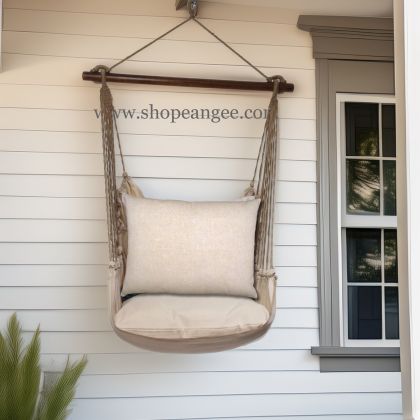 In a coastal inspired deck chair a multi colored outdoor swing crafted by the artisans of Magnolia Casual called the Swing Set 4 piece Latte Solid w/ Latte Solid is displayed featuring 100 percent weather resistant fabric, weather resistant polyester fabric, handcrafted adding comfort and style to the space.
