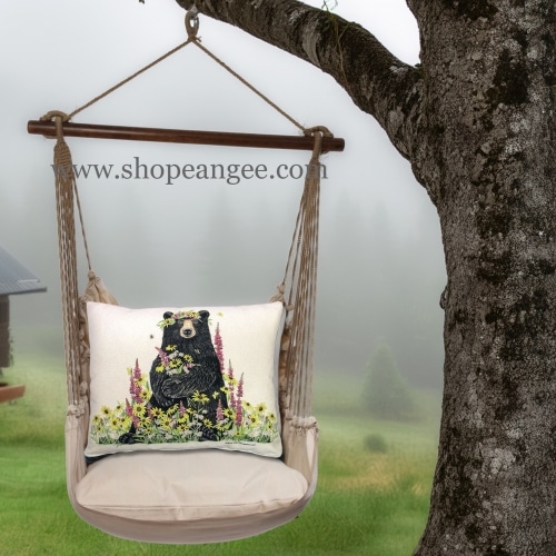 In an outdoor reading nook a multi colored outdoor swing crafted by the artisans of Magnolia Casual called the Swing Set 4 piece Latte Solid w/ Wildflower Bear is displayed featuring 100 percent weather resistant fabric, weather resistant polyester fabric, handcrafted adding comfort and style to the space.