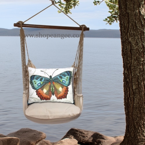 In an outdoor reading nook a multi colored outdoor swing crafted by the artisans of Magnolia Casual called the Swing Set 4 piece Latte Solid w/ Butterfly M2 is displayed featuring 100 percent weather resistant fabric, weather resistant polyester fabric, handcrafted adding comfort and style to the space featuring with a butterfly motif.