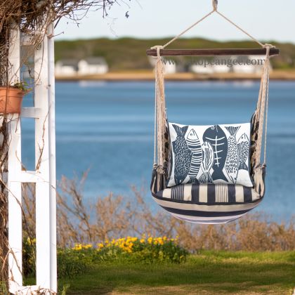 In a coastal inspired deck chair a multi colored outdoor swing crafted by the artisans of Magnolia Casual called the Swing Set 4 piece Marina Stripe w/ Fish is displayed featuring 100 percent weather resistant fabric, weather resistant polyester fabric, handcrafted adding comfort and style to the space featuring with a stripe motif.
