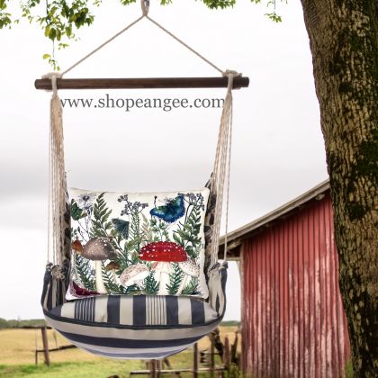 In a cozy garden seating area a multi colored outdoor swing crafted by the artisans of Magnolia Casual called the Swing Set 4 piece Marina Stripe w/ Botanical Mushrooms 1 is displayed featuring 100 percent weather resistant fabric, weather resistant polyester fabric, handcrafted adding comfort and style to the space featuring with a stripe motif.