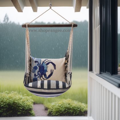 In a sunlit patio lounge a multi colored outdoor swing crafted by the artisans of Magnolia Casual called the Swing Set 4 piece Marina Stripe w/ Crab is displayed featuring 100 percent weather resistant fabric, weather resistant polyester fabric, handcrafted adding comfort and style to the space featuring with a stripe motif.