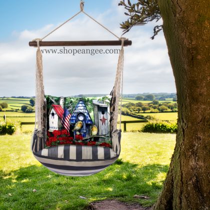 In a shaded porch swing a multi colored outdoor swing crafted by the artisans of Magnolia Casual called the Swing Set 4 piece Marina Stripe w/ Americana Birdhouse is displayed featuring 100 percent weather resistant fabric, weather resistant polyester fabric, handcrafted adding comfort and style to the space featuring with a stripe motif.