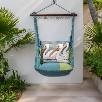 In a cozy garden seating area a multi colored outdoor swing crafted by the artisans of Magnolia Casual called the Swing Set 4 piece Meadow Mist Stripe w/ 3 Pelicans Swimming is displayed featuring 100 percent weather resistant fabric, weather resistant polyester fabric, handcrafted, natural materials adding comfort and style to the space featuring with a stripe motif.