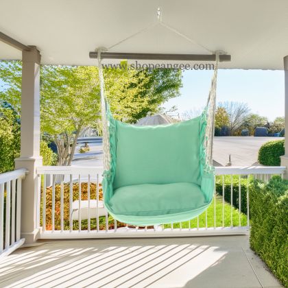In a sunlit patio lounge a green outdoor swing crafted by the artisans of Magnolia Casual called the Swing Set 4 piece Seafoam Green Solid w/ Seafoam Green Solid is displayed featuring 100 percent weather resistant fabric, weather resistant polyester fabric, handcrafted adding comfort and style to the space featuring shades of green.
