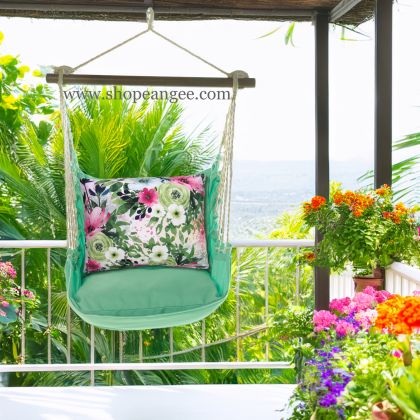 In an outdoor reading nook a green outdoor swing crafted by the artisans of Magnolia Casual called the Swing Set 4 piece Seafoam Green Solid w/ Meadow Dance 2 is displayed featuring 100 percent weather resistant fabric, weather resistant polyester fabric, handcrafted adding comfort and style to the space featuring shades of green.