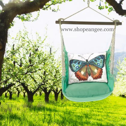 In an outdoor reading nook a green outdoor swing crafted by the artisans of Magnolia Casual called the Swing Set 4 piece Seafoam Green Solid w/ Butterfly M2 is displayed featuring 100 percent weather resistant fabric, weather resistant polyester fabric, handcrafted adding comfort and style to the space featuring with a butterfly motif and shades of green.