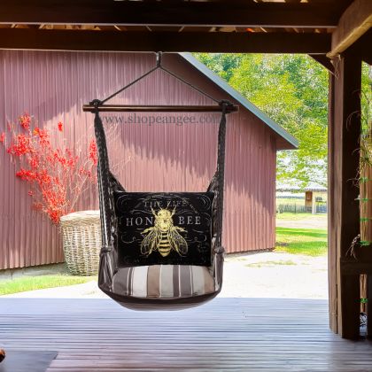 In a shaded porch swing a black outdoor swing crafted by the artisans of Magnolia Casual called the Swing Set 4 piece Slate Gray Stripe w/ Vintage Bee on Black is displayed featuring 100 percent weather resistant fabric, weather resistant polyester fabric, handcrafted adding comfort and style to the space featuring with a stripe motif and shades of gray and black.