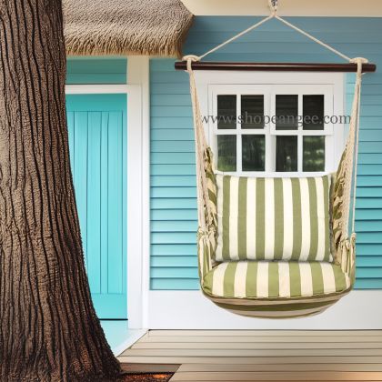 In an outdoor reading nook a multi colored outdoor swing crafted by the artisans of Magnolia Casual called the Swing Set 4 piece Summer Palms Stripe w/ Summer Palms Stripe is displayed featuring 100 percent weather resistant fabric, weather resistant polyester fabric, handcrafted adding comfort and style to the space featuring with a stripe motif.