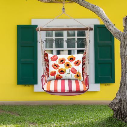 In a shaded porch swing a multi colored outdoor swing crafted by the artisans of Magnolia Casual called the Swing Set 4 piece Cristina Stripe w/ Poppy Blossoms is displayed featuring 100 percent weather resistant fabric, weather resistant polyester fabric, handcrafted adding comfort and style to the space featuring with a stripe motif.