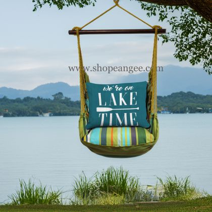 In a shaded porch swing a teal outdoor swing crafted by the artisans of Magnolia Casual called the Swing Set 4 piece Citrus Stripe w/ Lake Time on Teal is displayed featuring 100 percent weather resistant fabric, weather resistant polyester fabric, handcrafted adding comfort and style to the space featuring with a stripe motif and shades of teal.