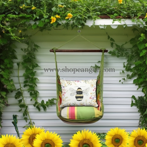In an outdoor reading nook a multi colored outdoor swing crafted by the artisans of Magnolia Casual called the Swing Set 4 piece Fresh Lime Stripe w/ Floral Bee is displayed featuring 100 percent weather resistant fabric, weather resistant polyester fabric, handcrafted adding comfort and style to the space featuring with a stripe motif and shades of lime.