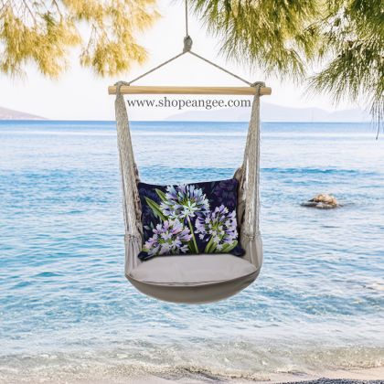 In a coastal inspired deck chair a gray outdoor swing crafted by the artisans of Magnolia Casual called the Swing Set 4 piece Gray Solid w/ Midnight Garden Lilies is displayed featuring 100 percent weather resistant fabric, weather resistant polyester fabric, handcrafted adding comfort and style to the space featuring shades of gray.