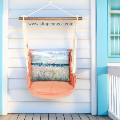 In a sunlit patio lounge a multi colored outdoor swing crafted by the artisans of Magnolia Casual called the Swing Set 4 piece Living Coral w/ Coastal Landscape 2 is displayed featuring 100 percent weather resistant fabric, weather resistant polyester fabric, handcrafted adding comfort and style to the space featuring with a coral motif and shades of coral.