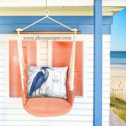 In a sunlit patio lounge a multi colored outdoor swing crafted by the artisans of Magnolia Casual called the Swing Set 4 piece Living Coral w/ Majestic Heron is displayed featuring 100 percent weather resistant fabric, weather resistant polyester fabric, handcrafted adding comfort and style to the space featuring with a coral motif and shades of coral.