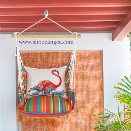 In a poolside chaise a pink outdoor swing crafted by the artisans of Magnolia Casual called the Swing Set 4 piece Le Jardin Stripe w/ Vivid Flamingo Pink is displayed featuring 100 percent weather resistant fabric, weather resistant polyester fabric, handcrafted adding comfort and style to the space featuring with a stripe motif and shades of pink.