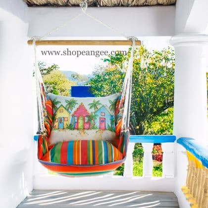 In a coastal inspired deck chair a multi colored outdoor swing crafted by the artisans of Magnolia Casual called the Swing Set 4 piece Le Jardin Stripe w/ Colorful Beach Cottages is displayed featuring 100 percent weather resistant fabric, weather resistant polyester fabric, handcrafted adding comfort and style to the space featuring with a stripe motif.