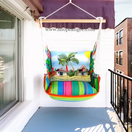 In a poolside chaise a multi colored outdoor swing crafted by the artisans of Magnolia Casual called the Swing Set 4 piece Le Jardin Nouveau w/ Surf Shacks is displayed featuring 100 percent weather resistant fabric, weather resistant polyester fabric, handcrafted adding comfort and style to the space.