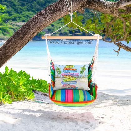 In a cozy garden seating area a multi colored outdoor swing crafted by the artisans of Magnolia Casual called the Swing Set 4 piece Le Jardin Nouveau w/ Beach Signs is displayed featuring 100 percent weather resistant fabric, weather resistant polyester fabric, handcrafted adding comfort and style to the space.